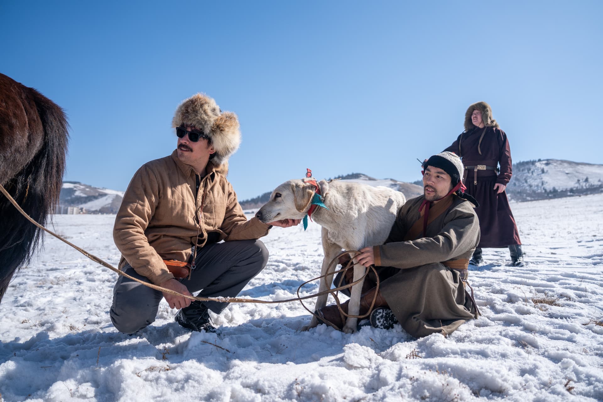 Jason and a Mongolian horseman with a dog in the snowy taiga